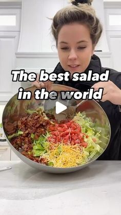 a woman is cooking salad in the kitchen with words above her that read, the best salad in the world