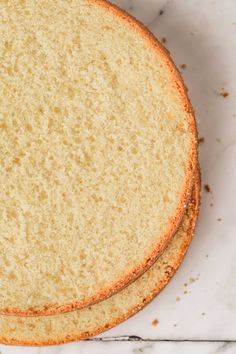 two slices of cake sitting on top of a white countertop next to each other