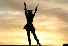 the silhouette of a woman with her arms in the air, wearing a dress and hat