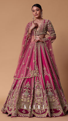 a woman in a pink lehenga with gold embroidery on the chest and sleeves