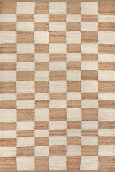 an area rug with checkered design in brown, white and beige colors on the floor