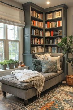 a living room filled with lots of furniture and bookshelves next to a window