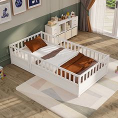 a white bed sitting on top of a wooden floor next to a dresser and window