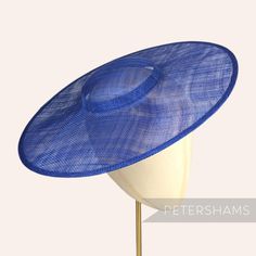 *This is not a fitted hat! You will need to attach a headband, comb or elastic to secure it to your head* This deep royal blue cartwheel hat base is a classic shape that has sprung into popularity in the past year. Made from 2 layers of stiffened sinamay, these cartwheels are ready to trim and are fitted with a petersham ribbon on the inside crown edge. Simply add a comb or headband to secure to the head. Hat base measures: Width: 35.5cm (14 inches) Crown Width: 13.5cm (5.3 inches) Crown Height: Cartwheel Hat, Sinamay Fabric, Sinamay Fascinator, Blank Hats, Millinery Supplies, Hat Base, Deep Royal Blue, Velvet Flowers, Fascinator Hat