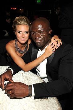 a man and woman sitting next to each other at a table