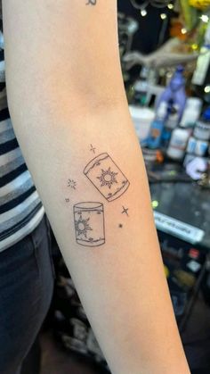 a woman's arm with a tattoo on it and an image of a jar