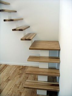 a set of wooden stairs in a white room