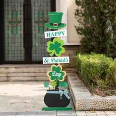 a st patrick's day yard sign with shamrocks and a top hat on it