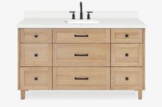 a bathroom vanity with white counter top and wooden cabinet doors, two faucets on each side