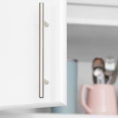 a close up view of the handle on a cabinet door with spoons and utensils in the background