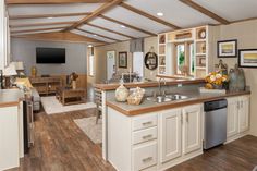 an open concept kitchen and living room with wood flooring