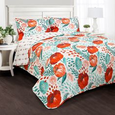 an orange and blue floral print bed spread with matching pillow shampoos on a wooden floor