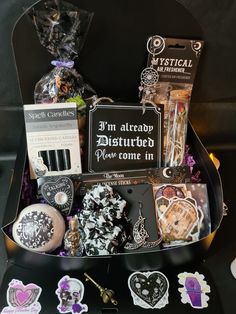 a box filled with lots of assorted items on top of a black tablecloth