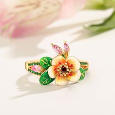 Pear blossoms traditionally represent purity, love, and longevity in Chinese culture and are also considered one of the most beautiful flowers when they are kissed with raindrops, sometimes used to describe attractive women, further promoting the flower's feminine nature. The ring features pear blossoms and leaves that wrap around your finger, detailed with bright enamel for lovers of colour! The perfect accessory for spring and summertime, or to keep the floral vibe going all year round.Carat W Nature-inspired Flower Shaped Ring As A Gift, Nature-inspired Flower Shaped Gift Ring, Blossom Flower-shaped Jewelry For Anniversary, Nature-inspired Flower Ring With Birth Flower Detail, Birth Flower Nature-inspired Ring, Nature-inspired Birth Flower Ring, White Flower Ring For Promise, Elegant Mother's Day Flower Ring, Spring Blossom Jewelry With Flower Decoration