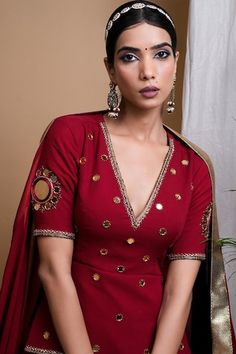 Maroon attached cancan lehenga with gota lace detailing on hem. Paired with a short kurta with hand embroidered mirrors, all over border work and a dupatta with hand embroidered gota lace on border with attached fringes. - Aza Fashions Festive Gota Work Sets With V-neck, Wedding Palazzo Set With Dupatta And V-neck, Festive V-neck Palazzo Set For Wedding, Festive V-neck Sharara With Dupatta, Festive V-neck Sets For Reception, V-neck Wedding Kurta With Pallu, Bollywood V-neck Sets With Mirror Work, Anarkali Set With Unstitched Blouse For Wedding, Navratri V-neck Mirror Work Sets