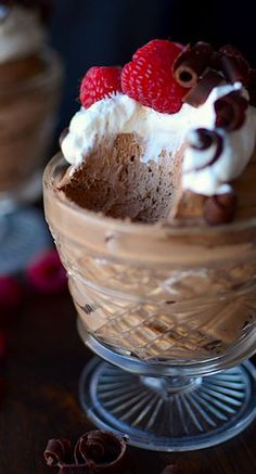 a dessert in a glass dish with raspberries on top