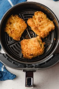 three fried chicken patties cooking in an air fryer