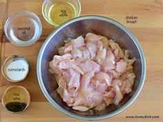 ingredients to make chicken broth sit in bowls on a wooden table