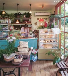 the interior of a bakery with lots of plants