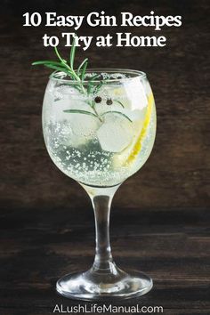 a gin cocktail in a wine glass with lemon and rosemary garnish on top