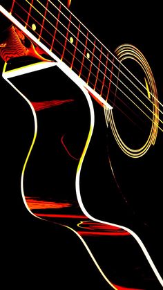 an acoustic guitar is lit up in red and yellow light, with the strings visible