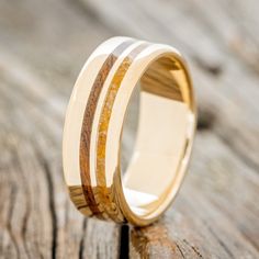 a wedding ring with wood and gold inlays