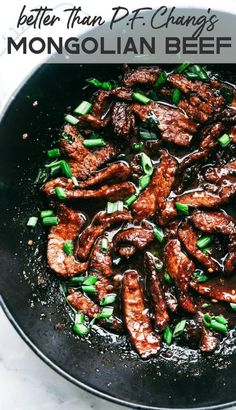 a skillet filled with meat and green onions