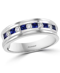 a white gold ring with blue sapphire stones and channeled diamonds on the side, set in