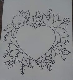 a drawing of a heart with flowers and leaves around it on a piece of paper