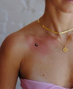 a woman wearing a gold choker and pink dress