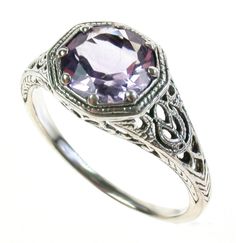 This beautiful Art Nouveau engagement ring has been crafted in precious metal Platinum. The highlight of this Vintage inspired ring are the gorgeous patterns on the shoulders and pierced gallery with a frilly pattern which surrounds the bezel. A claw set NATURAL Amethyst gemstone in the centre completes this elegant feminine ring. THIS VINTAGE INSPIRED AMETHYST RING IS TRULY AN EXQUISITE FINE JEWELLERY PIECE WHICH IS TO BE TREASURED FOR A LIFETIME ! * FREE GIFT BOX PROVIDED * ALL ITEMS PACKAGED Nouveau Engagement Ring, Vintage Platinum Rings, Art Nouveau Engagement Ring, White Engagement Ring, Amethyst Ring Vintage, Vintage Inspired Rings, Elegant Feminine, Platinum Ring, Multi Stone Ring