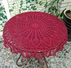 a red table sitting on top of a stone floor