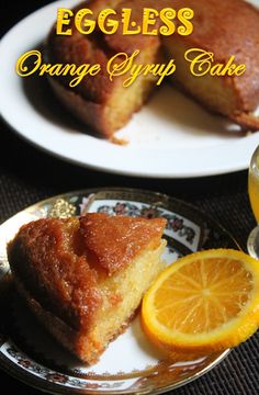 an eggless orange syrup cake on a plate next to a glass of orange juice