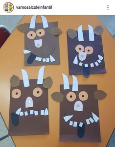 three brown paper bags with white horns on them and faces cut out to look like animals