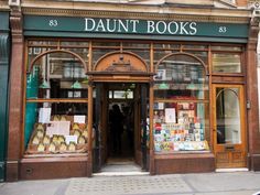 a store front with many books on display in it's windows and the door is open