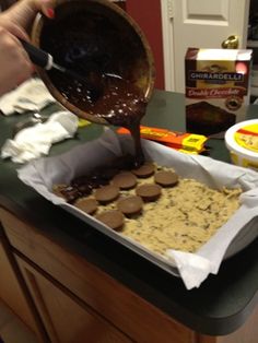 someone pouring chocolate into a pan on top of a counter