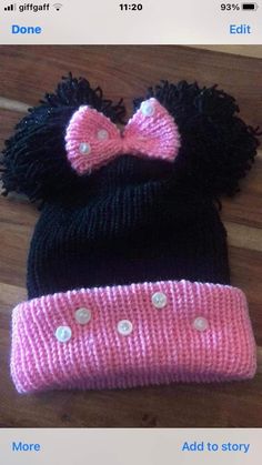 a knitted minnie mouse hat with a pink bow on the front and black ears