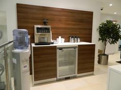 a modern kitchen with wood paneling on the wall and stainless steel appliance