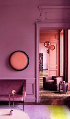 a living room filled with furniture and pink walls