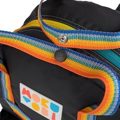 Our classic backpack in a monochrome color way with rainbow details! The ultimate go-to style. Mid-size backpack with a large wide-open front zipper pocket. 3D pockets on both sides to stash your umbrella or water bottle. Webbing tote handles featuring easy grab front and back strap with matching logo snap. Inside zipper pocket and back suitcase trolley sleeve for easy travel. Adjustable padded back straps with no fail construction. Zippered main compartment with pattern paracord pulls. Inside p Everyday Rainbow Backpack, Monochrome Color, Easy Travel, Classic Backpack, Black Mini, Back Strap, Front Open, Front Zipper, Zipper Pocket