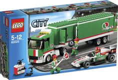 a green and white truck with two men on it's back in front of a box