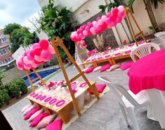 pink and white tables with balloons on them