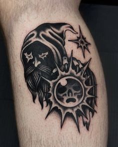 a black and white tattoo on the leg of a man