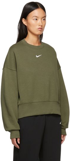 Long sleeve cotton-blend fleece sweatshirt in green. Rib knit crewneck collar, cuffs, and cropped hem. Logo embroidered in white at front. Supplier color: Medium olive/White Nike Oversized Sweatshirt, Nike Phoenix Fleece, Crewneck Sweatshirt Women, Oversized Crewneck, Cut Sweatshirts, Nike Sweatshirts, Fleece Sweatshirt, Crew Shirt, Sportswear Women