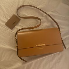 Rare Burberry Grace Shoulder Bag Very Lightly Used With Some Minor Imperfections On The Front Surface That Is Only Noticeable In Certain Lighting From Certain Angles (Seen In Third Photo). This Grace Bag Is A Bit Wider And Less Tall Than The Traditional Grace Bag From Burberry. Color: Tan Material: Leather Hardware: Gold Straps: Adjustable Dust Bag Not Included. Purchased From Ssense. Leather Hardware, Burberry Bag, Burberry, Dust Bag, Im Not Perfect, Bag Lady, Shoulder Bag, Lighting, Leather