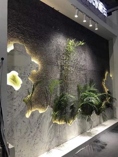 a wall with plants and lights on it