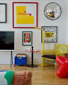 a living room filled with furniture and pictures on the wall above it's tv