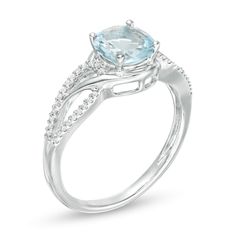 An entrancing choice, this fashion ring delivers eye-catching style. Crafted in sterling silver, this pleasing look features a 7.0mm lab-created icy-blue aquamarine. Bypassing ribbons surround the center and crossover sculpted diamond-adorned loops along the split shank. Captivating with 1/6 ct. t.w. of diamonds and a brilliant buffed luster, this design draws all the right kinds of attention. Custom-made to fit your ring size. Sterling silver rings cannot be resized after purchase. Fine Jewelry Ring With Round Cut Accent Stones, Fine Jewelry Round Cut Ring With Accent Stones, Diamond Ring With Accent Stones In 14k White Gold, Fine Jewelry Birthstone Ring With Diamond Accents, White Gold Ring With Accent Stones, Round Cut Topaz Ring With Diamond Accents, Fine Jewelry Halo Ring With Accent Stones For Promise, Round Blue Topaz Diamond Ring With Accents, Blue Topaz Diamond Ring With Accents