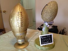 an egg shaped like a football on top of a table next to a sign that says no longer under it