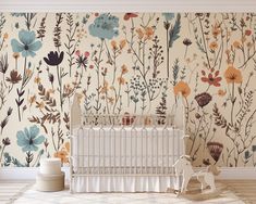 a baby's room with floral wallpaper and a crib in the foreground